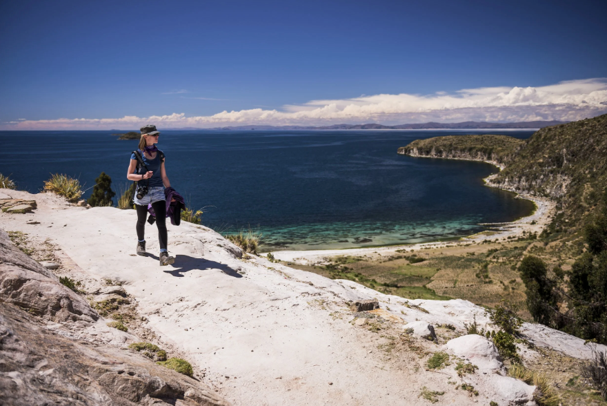 Hiking above a turquoise bay on Isla del Sol, Lake Titicaca