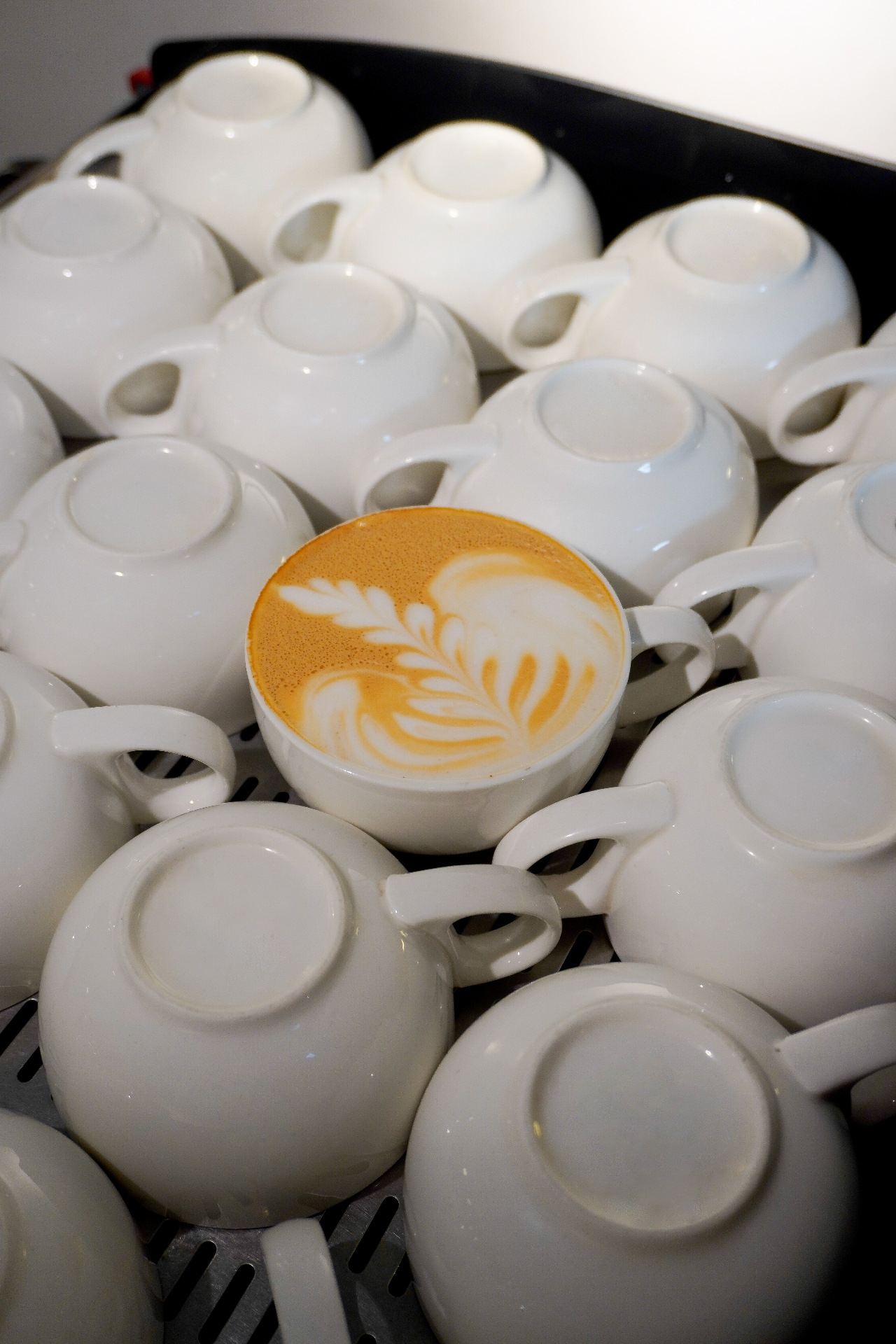 Cups warming on the espresso machine at Café del Mundo