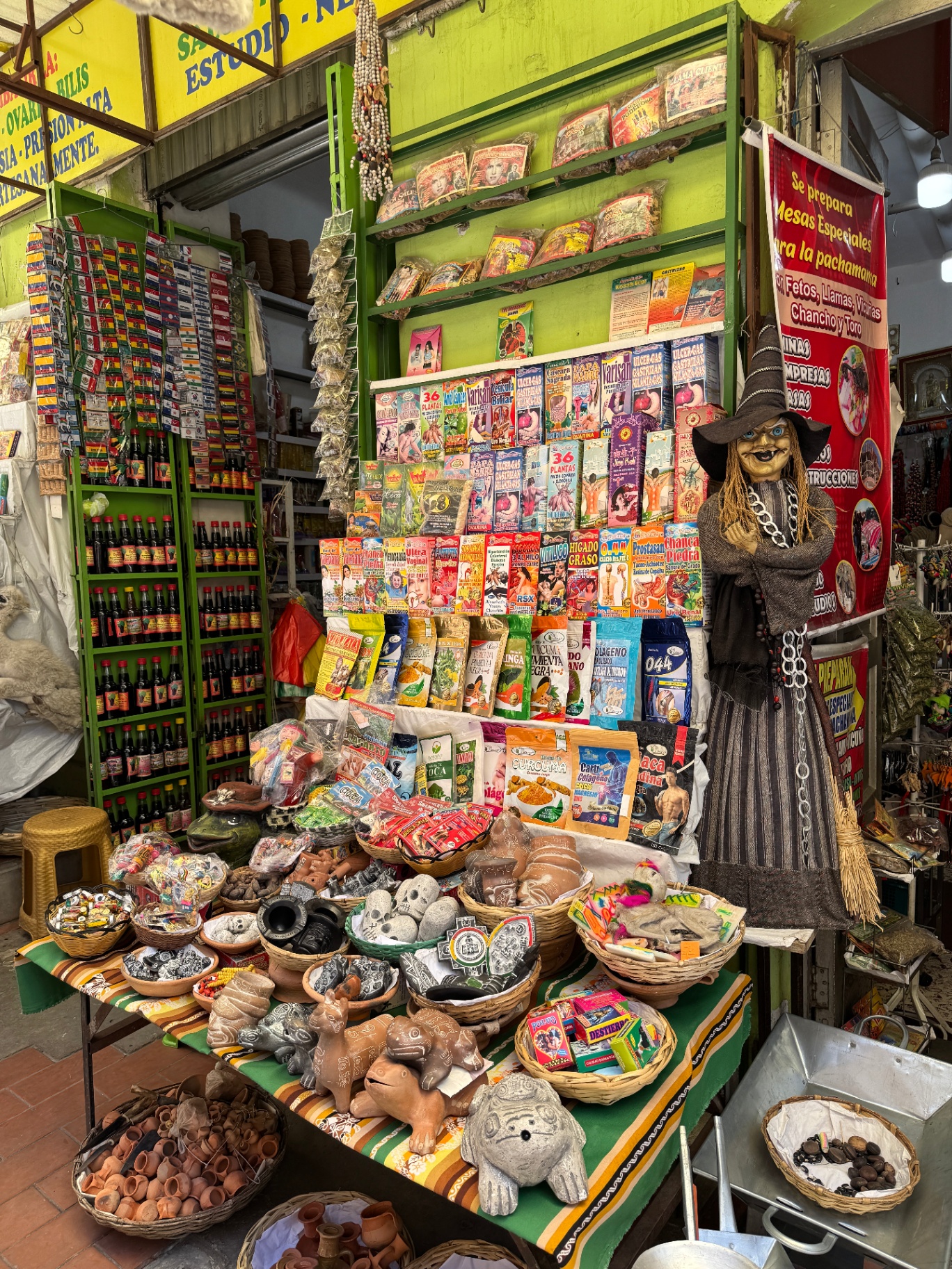 A colourful Witches’ Market stall filled with offerings, herbs and small ritual objects