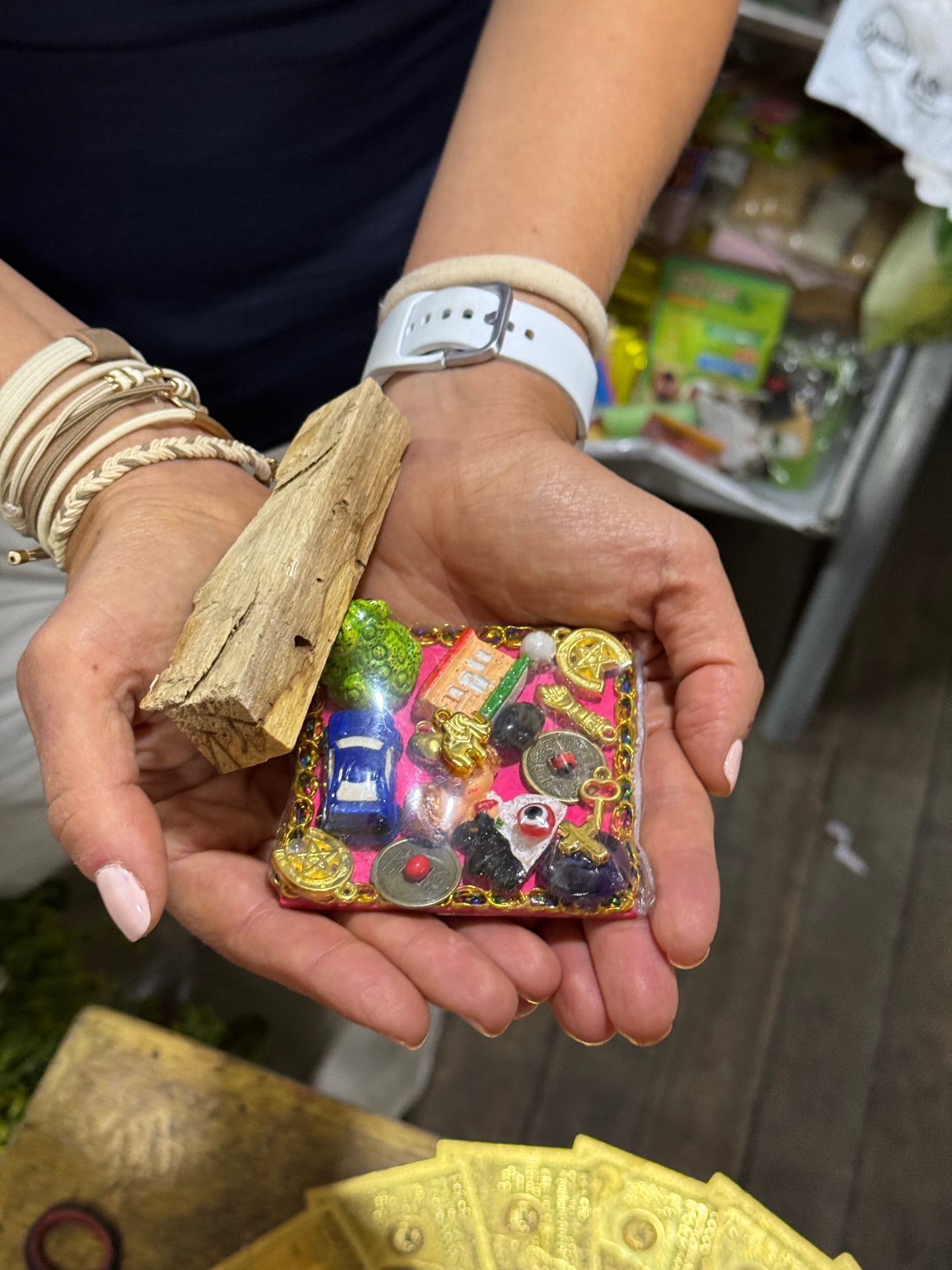 A colourful offering with miniature symbols, held carefully while learning about its meaning