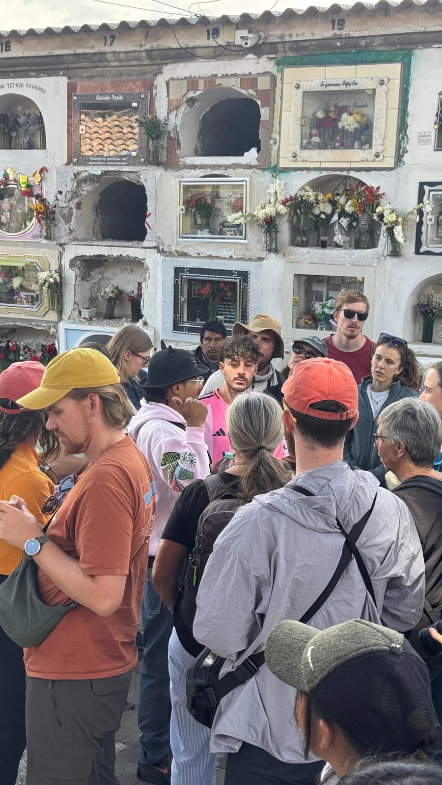 Travelers listening and learning at the Cementerio General in La Paz during Todos Santos
