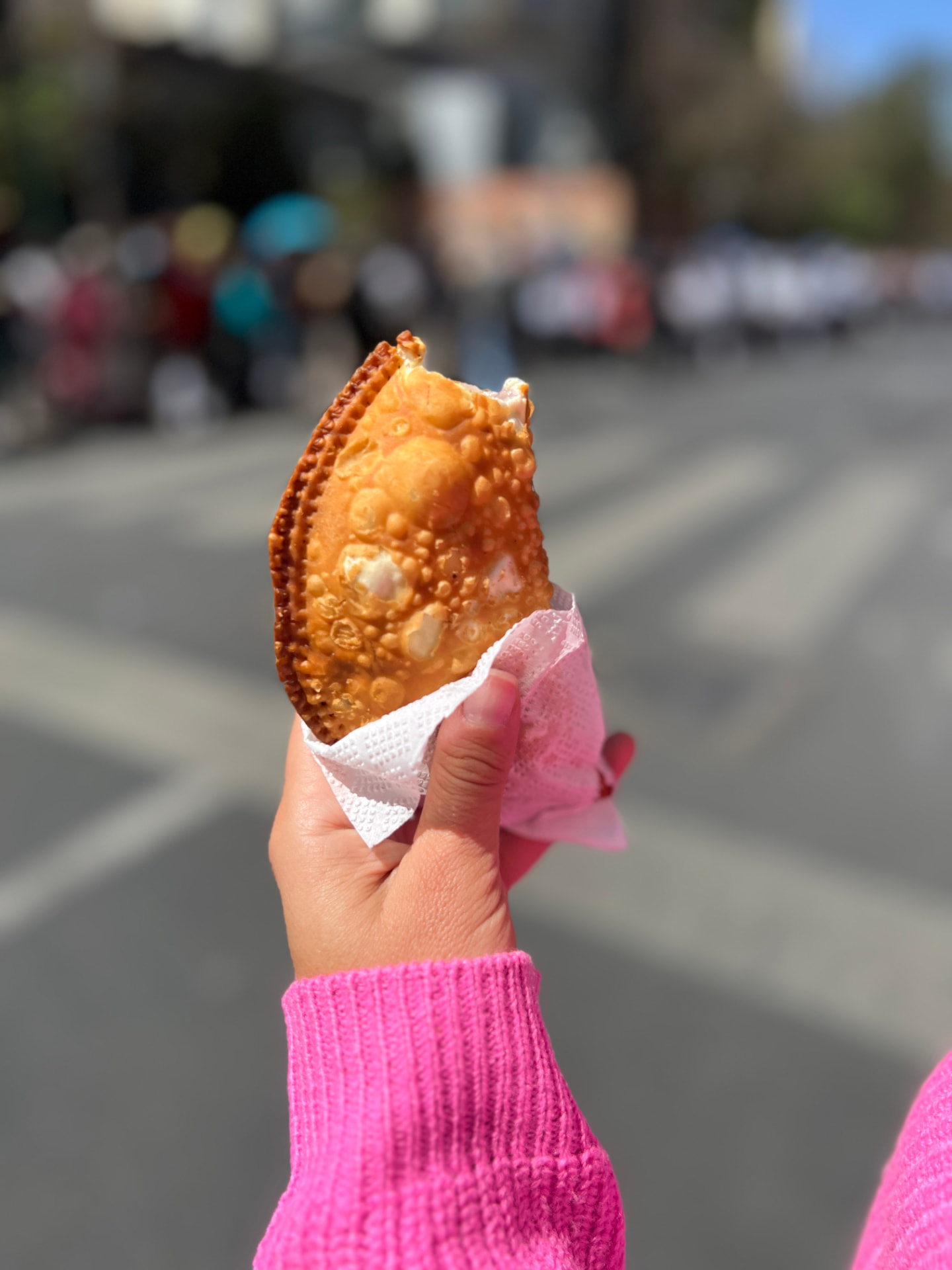 A golden fried tucumana from a La Paz street-food stall