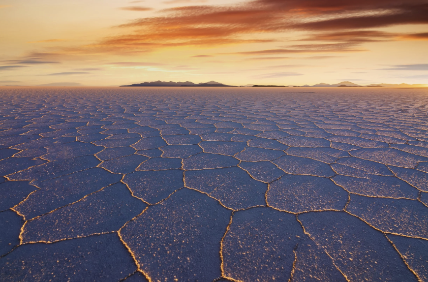 Sunset over the hexagonal salt tiles of the Salar de Uyuni